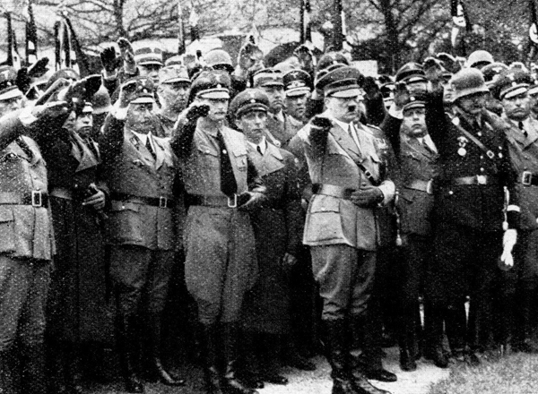 Adolf Hitler and officials salute at the funeral of Julius Schreck in Gräfelfing near Munich